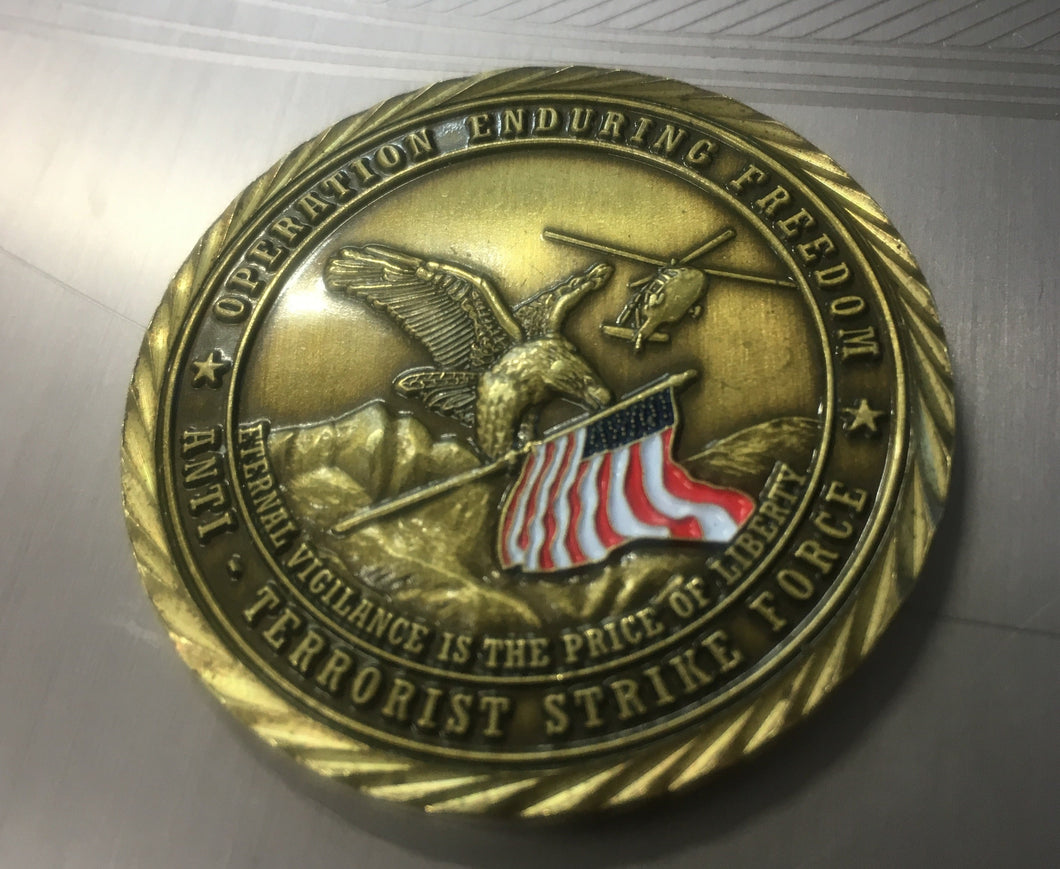 front view of operation enduring freedom challenge coin.  eagle, helicopter and american flag